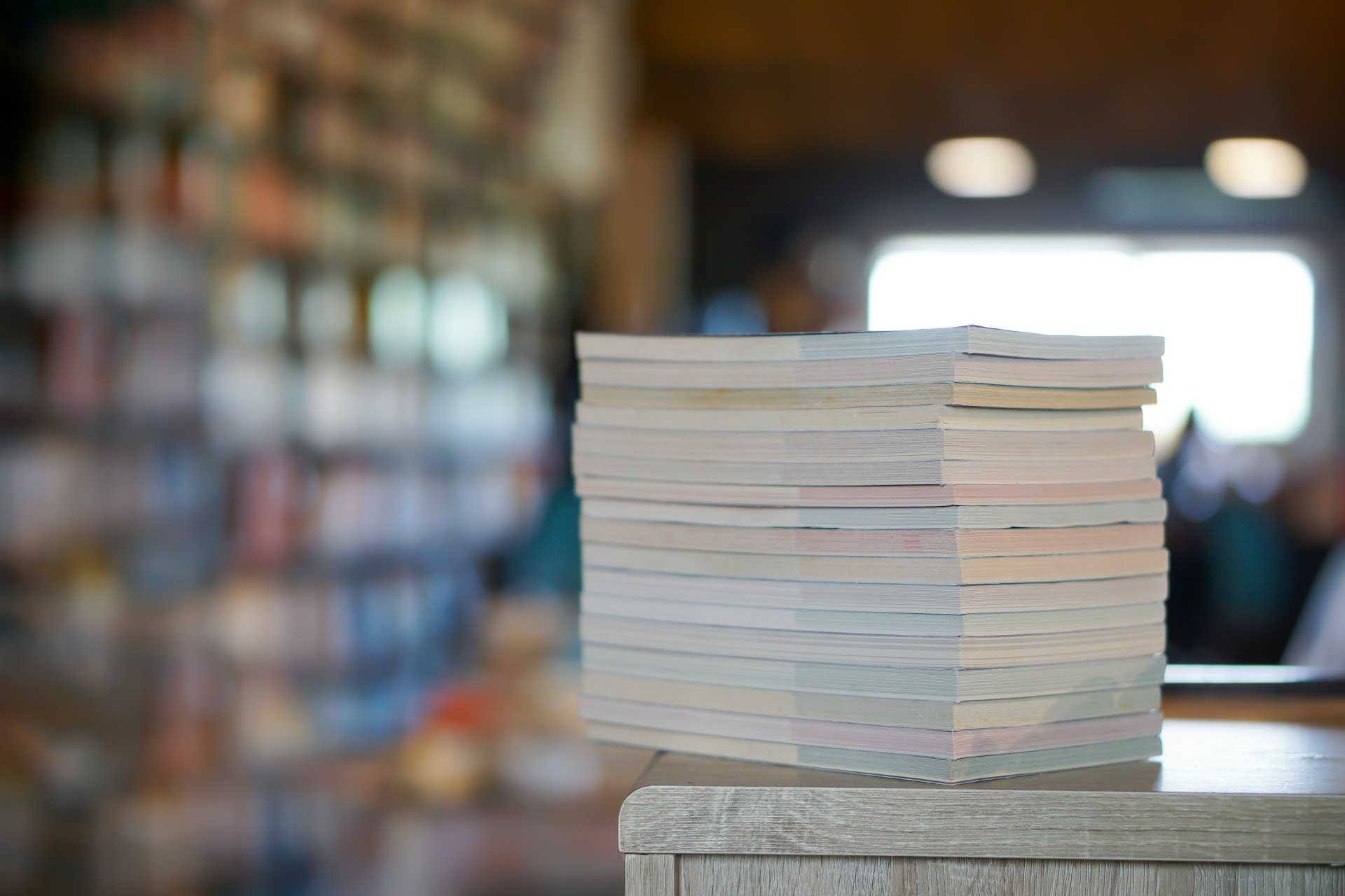a stack of papers sitting on top of a wooden table